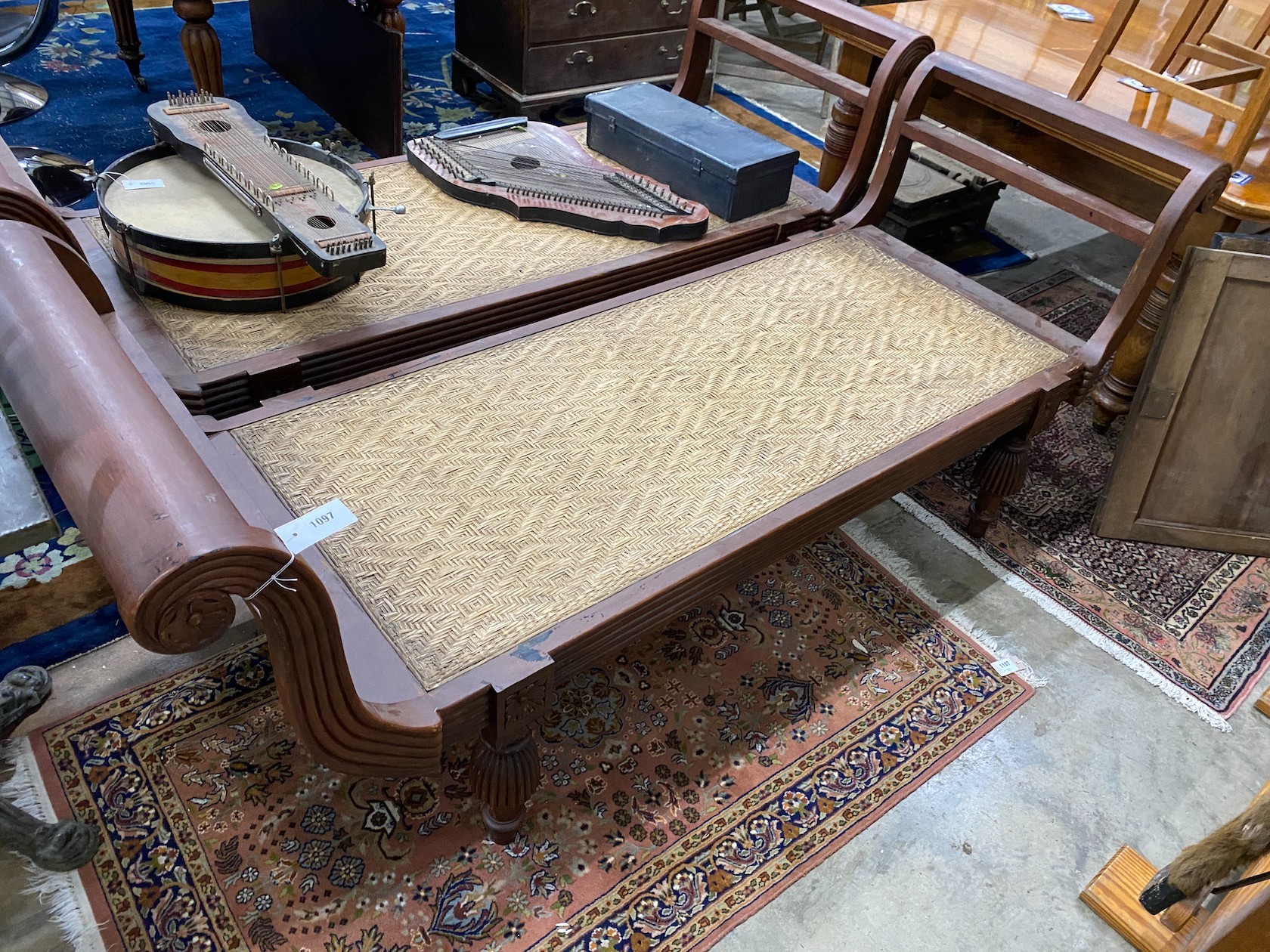 An Asian hardwood day bed with cane seat, length 210cm